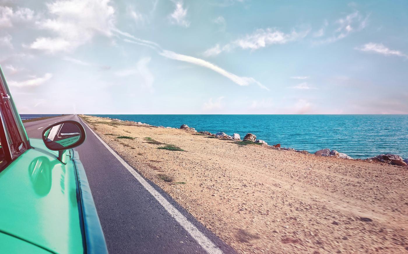 road next to beach by Simon Berger courtesy of Unsplash.
